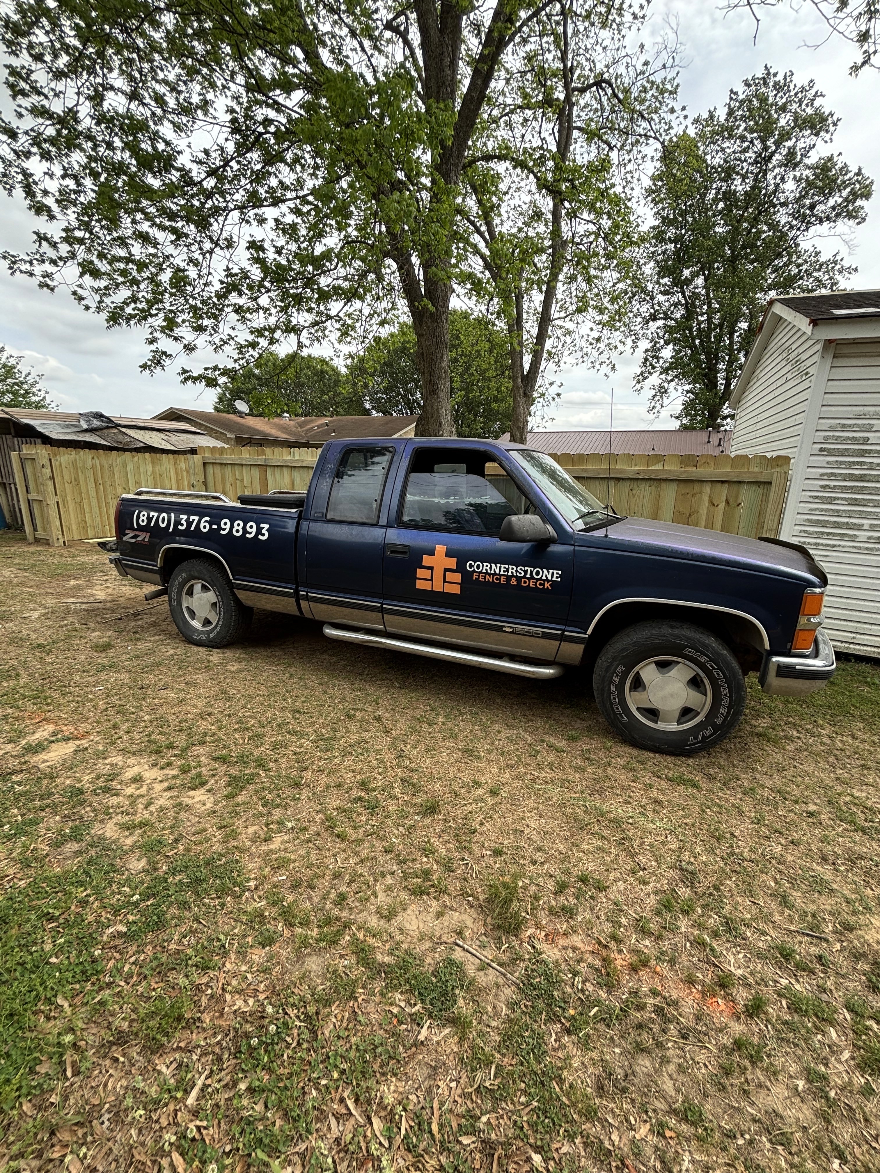 Cornerstone Fence and Deck owner in front of completed wood fence