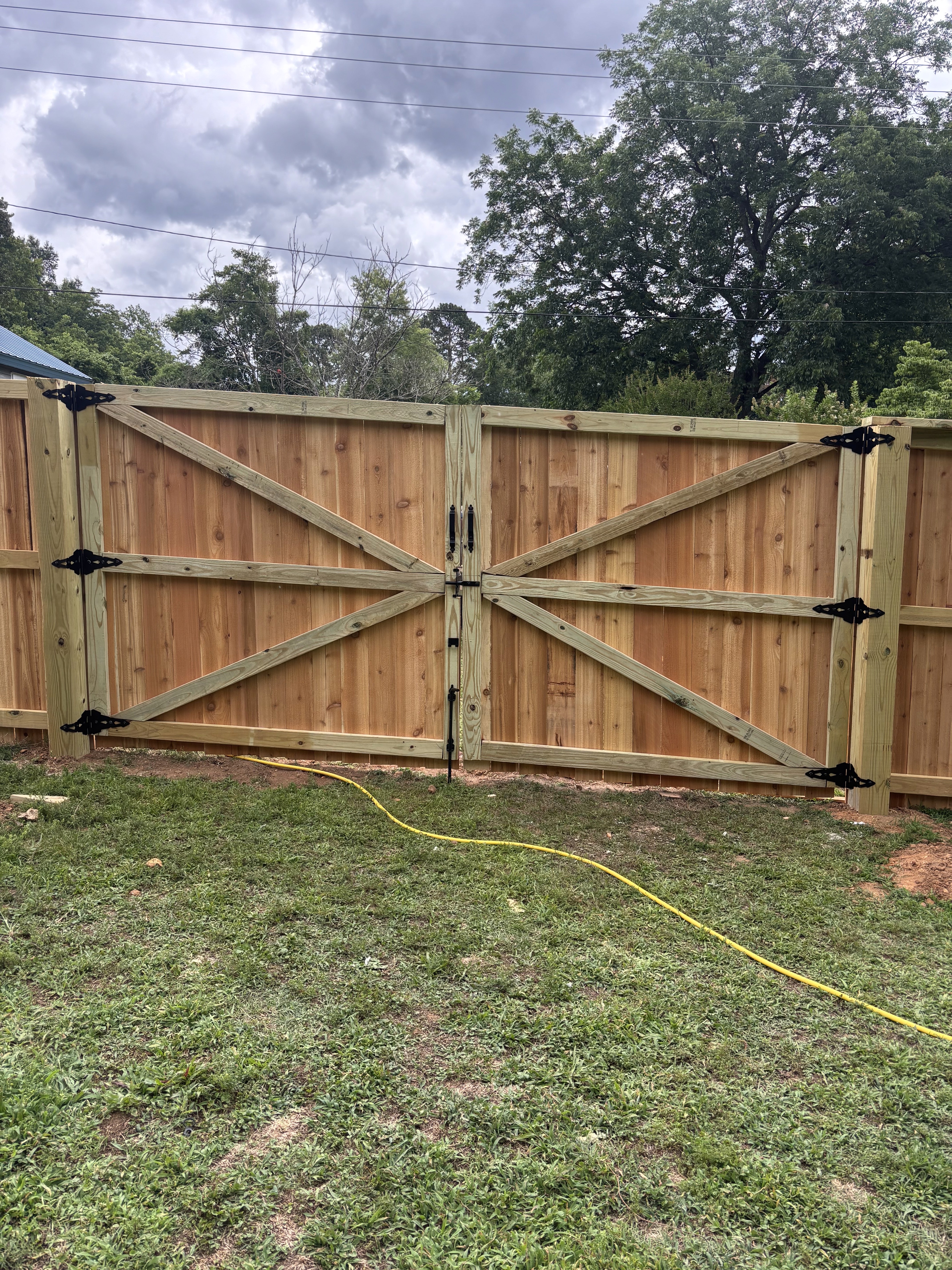 Completed white vinyl fence installation