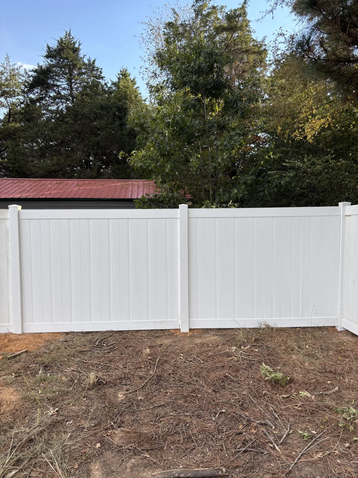 Completed white vinyl fence